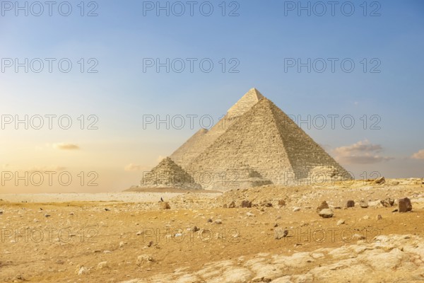 Ancient pyramids in desert of Cairo at sunset
