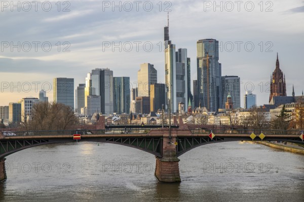 A big city in the evening at sunset. Modern buildings in a skyline by the river. Skyscrapers are reflected in the water. Modern architecture of the metropolis Frankfurt am Main, Germany, Europe