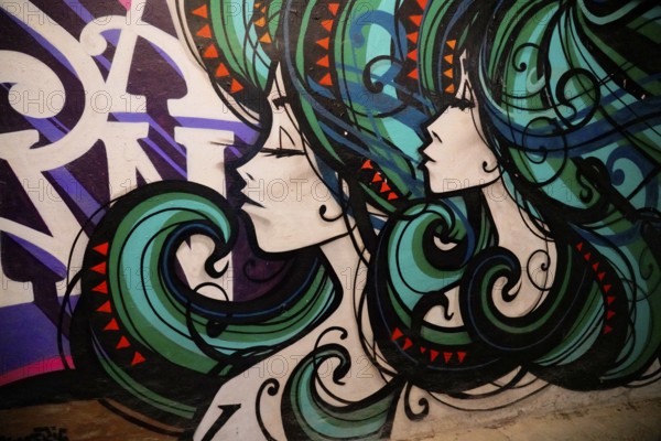 MAUSA VAUBAN, Museum of Urban Art and Street Art, Neuf-Brisach Fortress, France, Europe, Vivid depiction of two woman with ornate hair in shades of green and purple, Europe