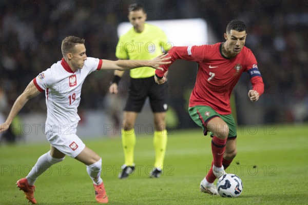 Football match, captain Cristiano RONALDO CR7 Portugal on the ball right in a duel with Dominik MARCZUK Poland, who tries to interfere with him with his right arm, Estadio do Dragao, Porto, Portugal, Europe