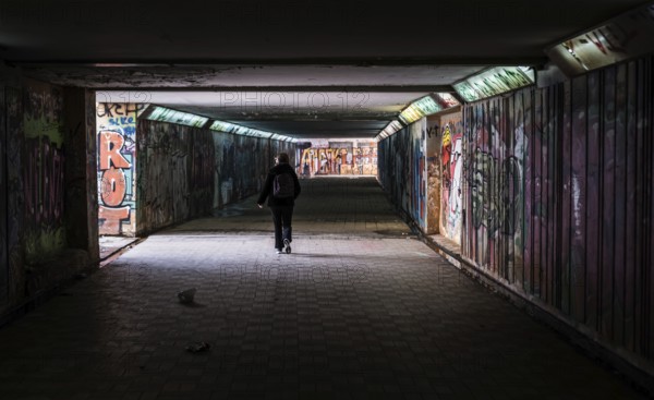 Freattyda, Athens, Greece, 12 28 2019 Torusit walking under a dark underpass tunnel, Europe