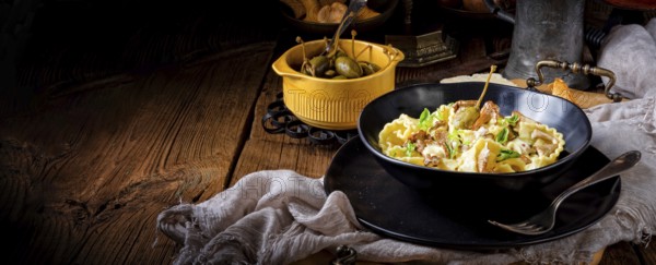 Reginette noodles in cream sauce with fresh chanterelles and capers