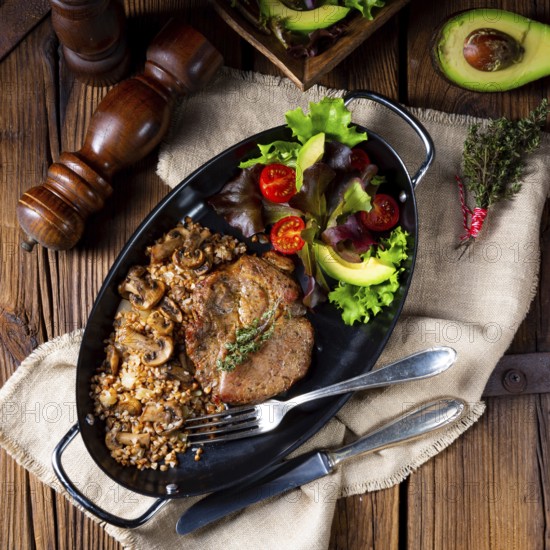 Pork steak with mushrooms and buckwheat groats and mango salad