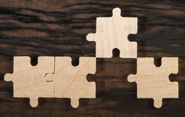 Wooden puzzle on dark wooden background