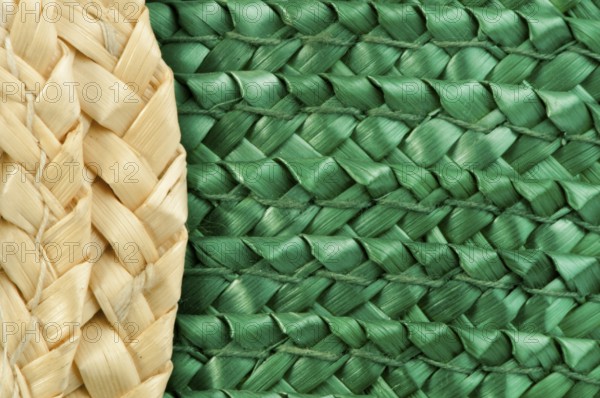 Woven straw natural background. Green and beige colors