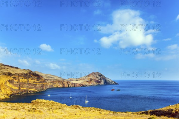 The west coast of the island of Madeira - the bay between the rocks with yachts and boats. Madeira is island in the Atlantic. The concept of active, ecological and photo tourism