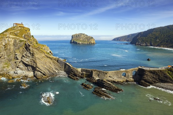 The most extraordinary coast of Spain. The island Gastelugache connected to the mainland by a bridge and a winding staircase. The Bay of Biscay, Basque Country. Photo taken from a drone