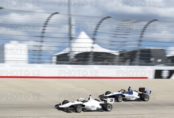 INDY NXT by Firestone Series driver, CHRISTIAN BROOKS (39) (R) of Santa Clarita, California races through the turns during the Big Machine Music City Grand Prix Presented by Gainbridge at Nashville Superspeedway in Lebanon, TN, Lebanon, United States of America, Asia