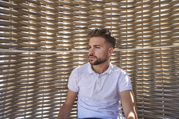Young beard man relaxed in a beach hammock