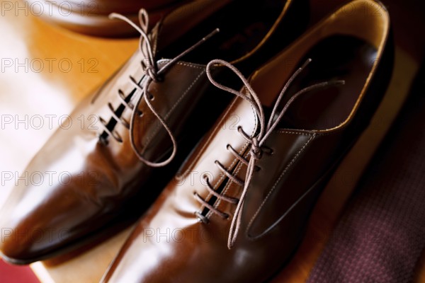 Men's brown shoes made of genuine leather with laces close-up.