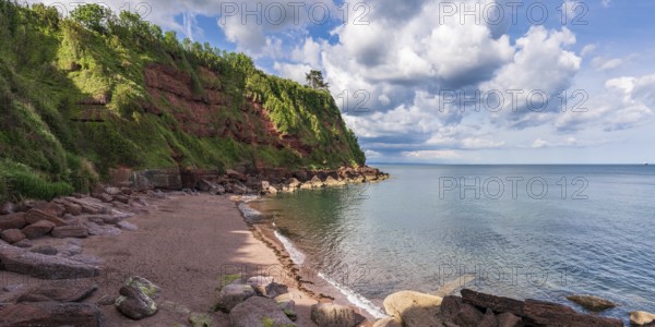 Clouds over the beach in Maidencombe, Torbay, England, UK