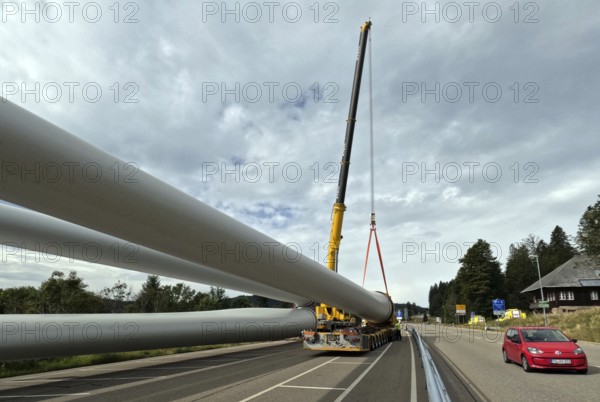 Like the pipes of a pipeline, the rotors lie on the self-propelled transporter ready for transport The heavy transport of the 68-metre-long rotor blades leads over the Feldberg (Breisgau-Hochschwarzwald district) to Freiburg's local mountain, the Schauinsland The rotor blades are mounted on a self-propelled transporter and travel at walking pace over several days to their destination Themed picture Wind energy, Feldberg in the Black Forest, Germany, Europe