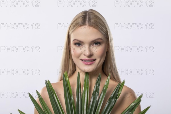 A serene, graceful woman gently cradling a lush aloe vera plant, embodying beauty, wellness, and natural elegance