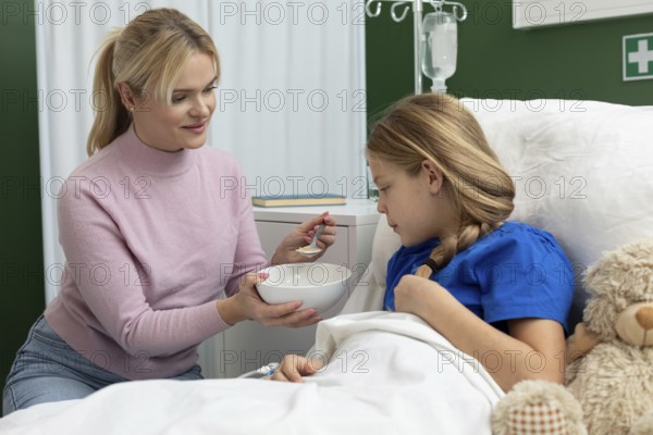 A caring moment between a mother and her daughter, showcasing love and support in a hospital setting