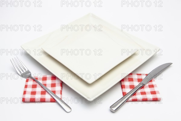 White square plate on the white wooden table.Top view.Flat Lay Image
