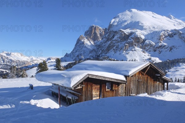 Wooden challet in the Dolomites mountain in winter