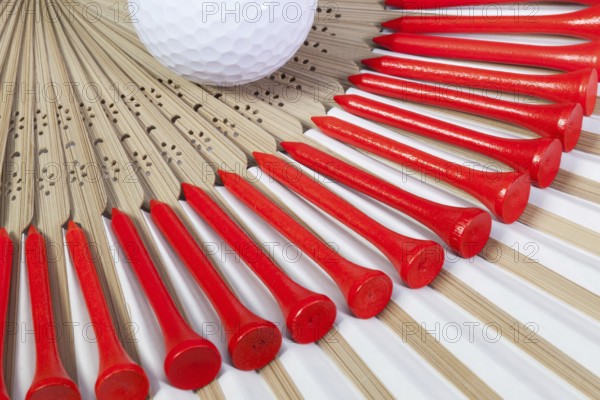 Typical Japanese hand fan made of bamboo and golf equipments