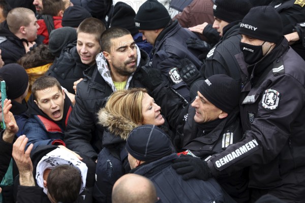 Sofia, Bulgaria - 12 January, 2022: People try to enter the Bulgarian Parliament building during a protest against green certificate (EU Digital COVID Certificate) and vaccination against COVID-19, Sofia, Bulgaria, Europe