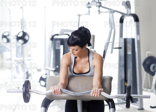 Woman with weight training equipment on sport gym club