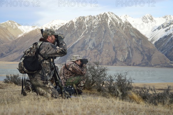 Two hunters searching for Himalayan tahr in the Southern Alps of New Zealand