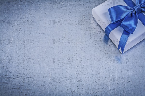Present box blue bow on metallic background copyspace celebrations concept