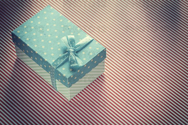 Present box on stripy tablecloth celebrations concept
