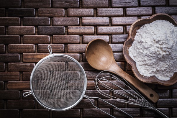 Wooden spoon bowl with flower egg whisk and sieve