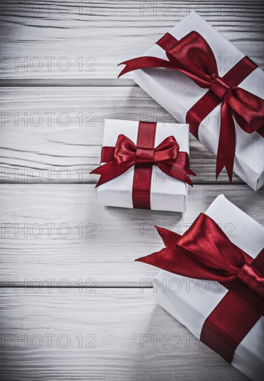 Wrapped present boxes on wooden board holidays concept
