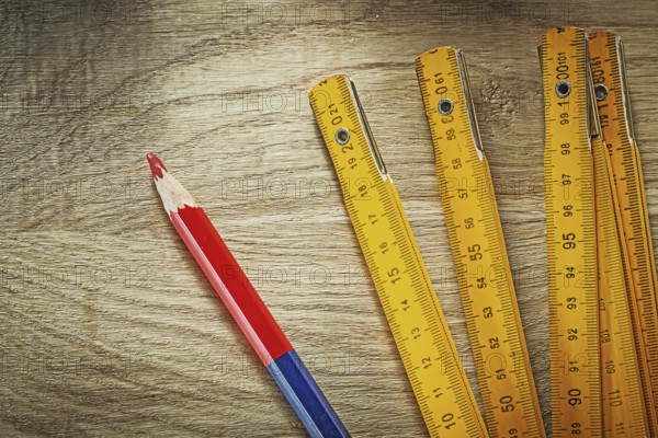 Wooden meter pencil on wood board construction concept