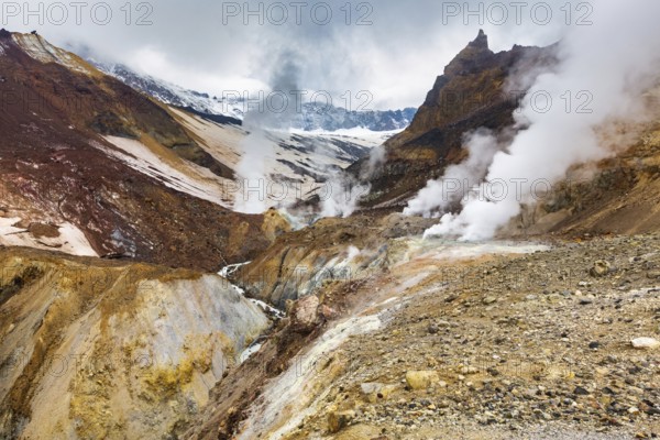 Majestic mountain landscape, crater of active volcano: hot spring and fumarole activity, lava plain. Stunning volcanic landscape, travel destinations for hiking, mountain climbing and active vacation
