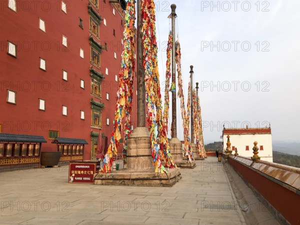Buddhist color prayer flags at The Putuo Zongcheng Buddhist Temple, one of the Eight Outer Temples of Chengde, built in 1767 and modeled after the Potala Palace of Tibet. Chengde, China, Asia