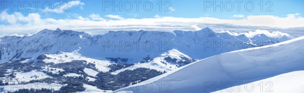 Beautiful panorama from the summit of Haengst close to Soerenberg, Switzerland. View over the karst slopes with ski traces towards the inner Alps