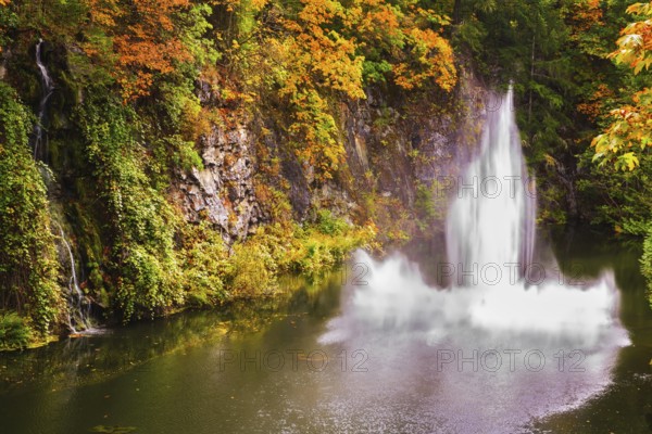 Dancing fountain in a quiet pond. Autumn day in the park. Butchart Gardens on Vancouver Island, Canada, North America