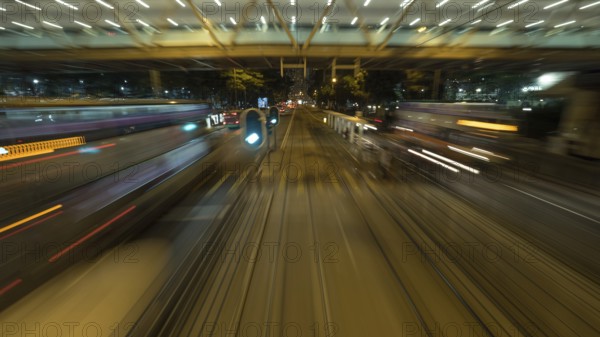 View to the road and transport from moving double-decker train. Shot in motion, Hong Kong, Asia