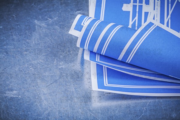 Blue construction plans on metallic background