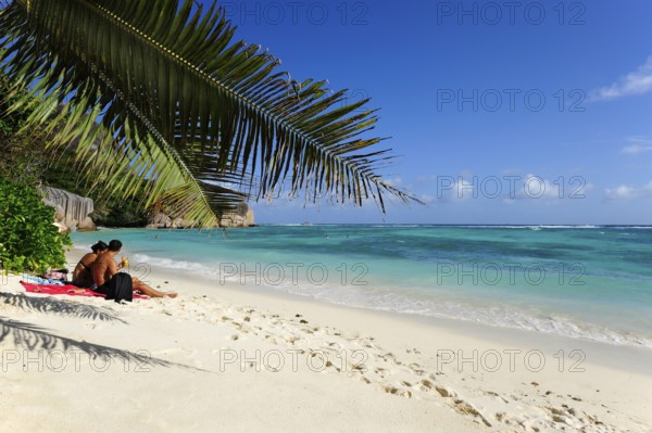 Couple on the beach Anse Source a Jean, Union Estate National Park, La Digue Island, the Seychelles, Indian Ocean