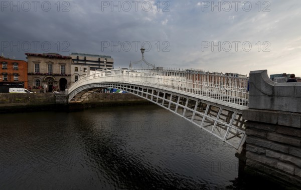 Dublin, Ireland, UK, June 19, 2022: Famous landmark of Ha' penny bridge over the river liffey Dublin, ireland, Europe