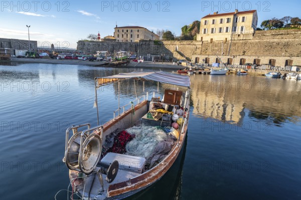 Small traditional fishing boat in Port Tino Rossi, the fishing and pleasure boat harbour near the citadel of Ajaccio, Corsica, France, Europe