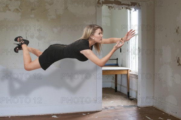 Beautiful young woman floating in the air
