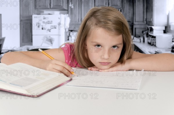 Pretty little girl doing her school homework