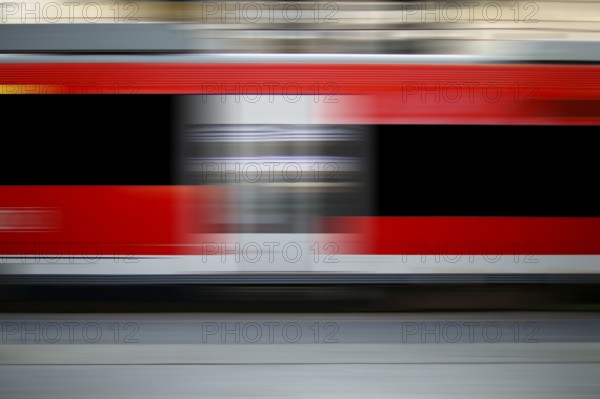 The abstract motion strips of a passing express train at a railway station