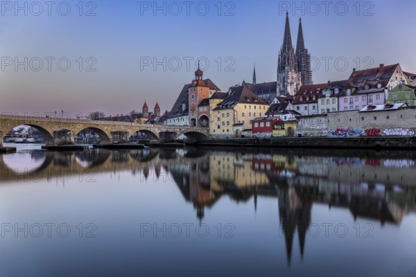 View over the Danube to the Regensburg Cathedral and the Stone Bridge in Regensburg, Bavaria, Germany, in the evening, Europe