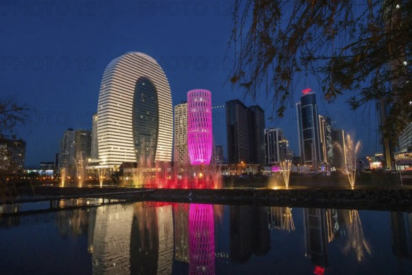 Amazing Panorama of evening Batume along coastline and reflection in pond with dancing fountains