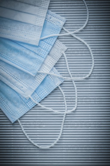 Set of medical disposable face masks on striped background