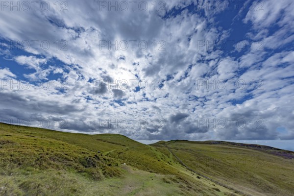 Vast rolling countryside with green meadows and sea views on the edge of Snowdonia National Park, Penmaenmawr, Dwygyfylchi, Caernarfonshire, Conwy County Borough, Wales, United Kingdom, Europe