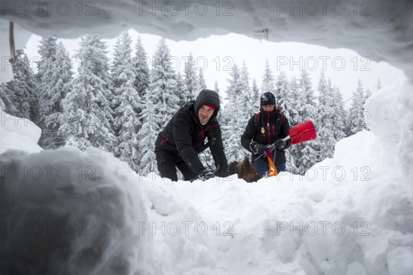 Sofia, Bulgaria - January 18, 2017: Rescuers from Mountain rescue service at Red Cross organization participate in a training with their dogs. Both men and animals are trained before going on duty