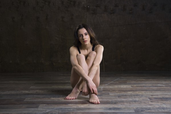 Abstract and stress emotional concept. depressed girl in lonely mood, theme of stressful. Sad woman sitting alone in empty room. Depression and chronic fatigue. female having psychological trauma