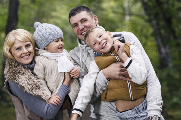 Close up portrait of a young family in the autumn park