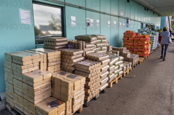 Plastic bags with wood pellets, wood briquettes and firewood at a wholesale market, Allgäu, Bavaria, Germany, Europe