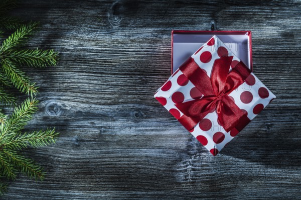 Present box fir tree branch on vintage wooden board